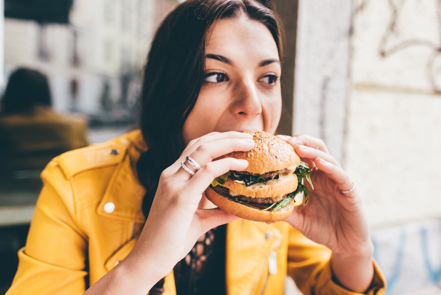 Young woman sitting in a restaurant eating 